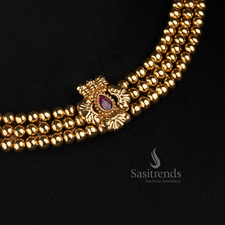 Sasitrends traditional antique gold necklace featuring several rows of rounded beads, a detailed teardrop centre pendant and ornamental earrings 