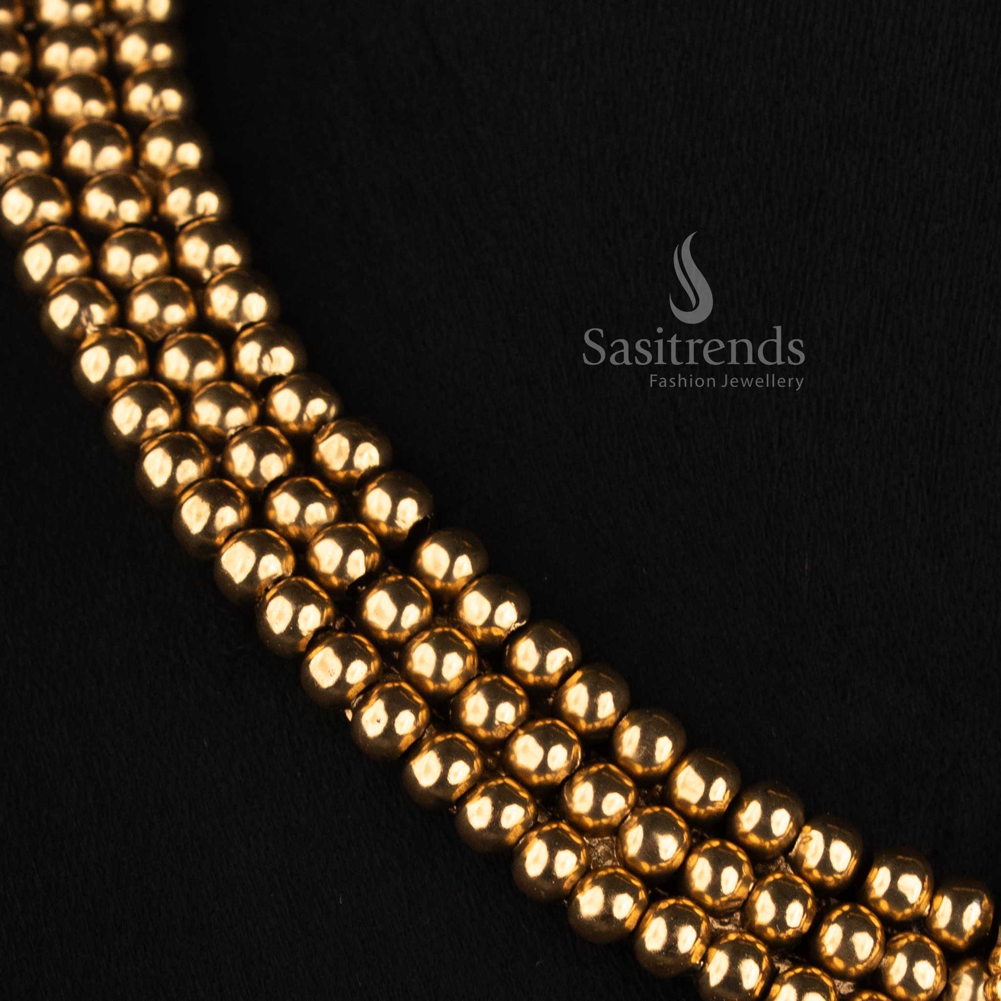 Sasitrends antique gold plated layered bead jewellery set with broad choker silhouette, floral-inspired pendant detailing and teardrop stone design 