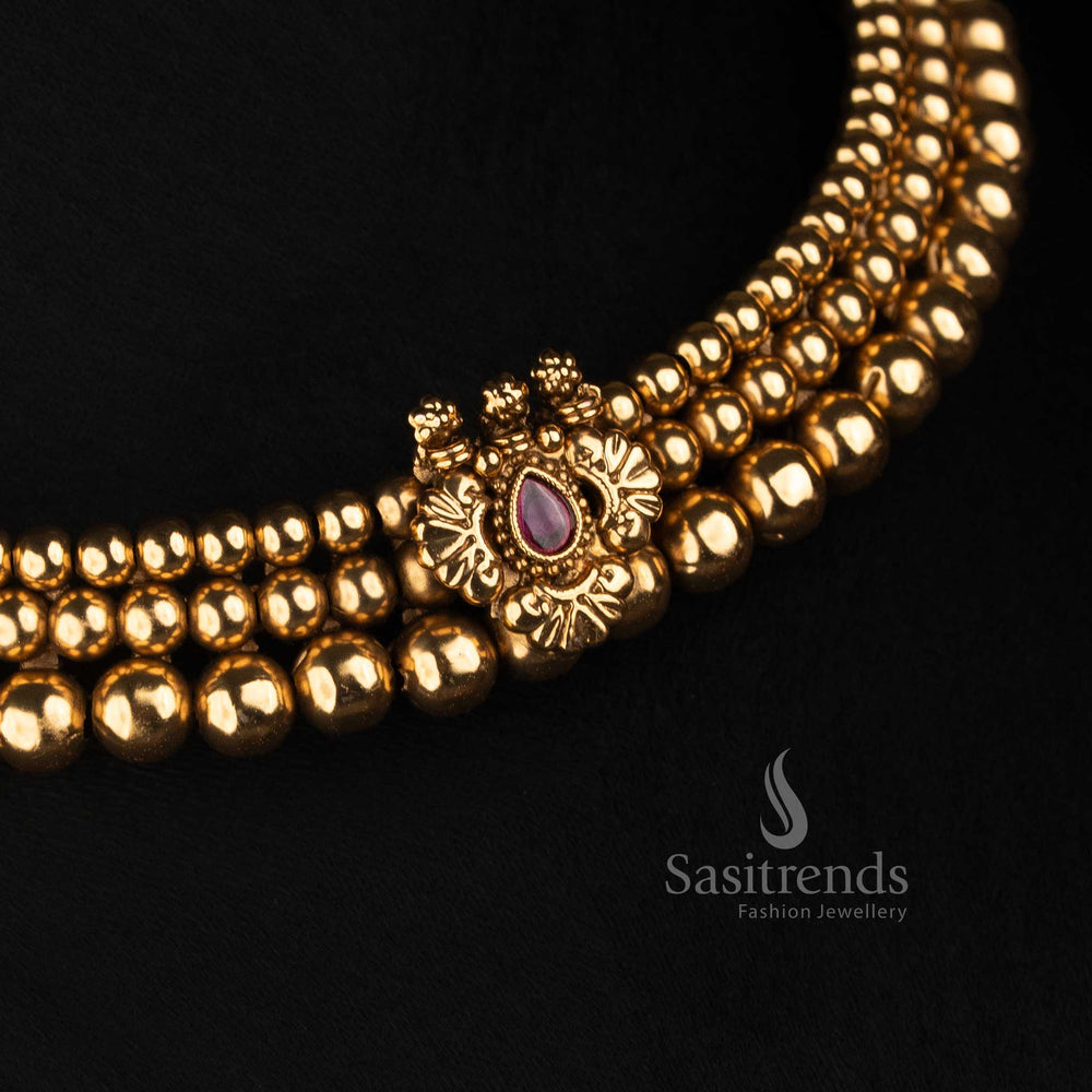 Sasitrends layered antique gold choker featuring graduated rounded bead rows, floral centre pendant with teardrop stone and detailed earrings 