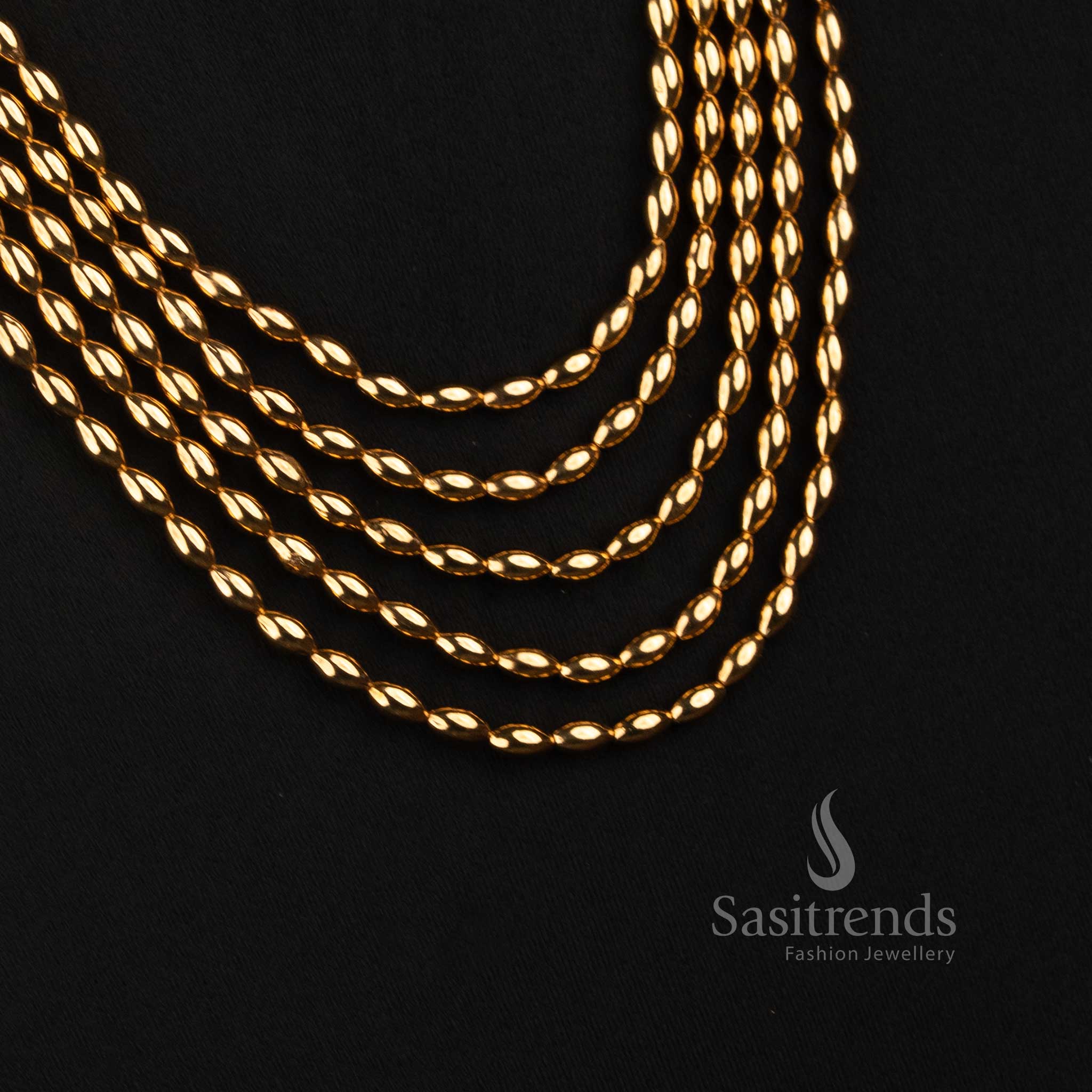 Sasitrends traditional long layered necklace featuring five flowing rows of rounded linked beads with detailed ornamental jhumka earrings 
