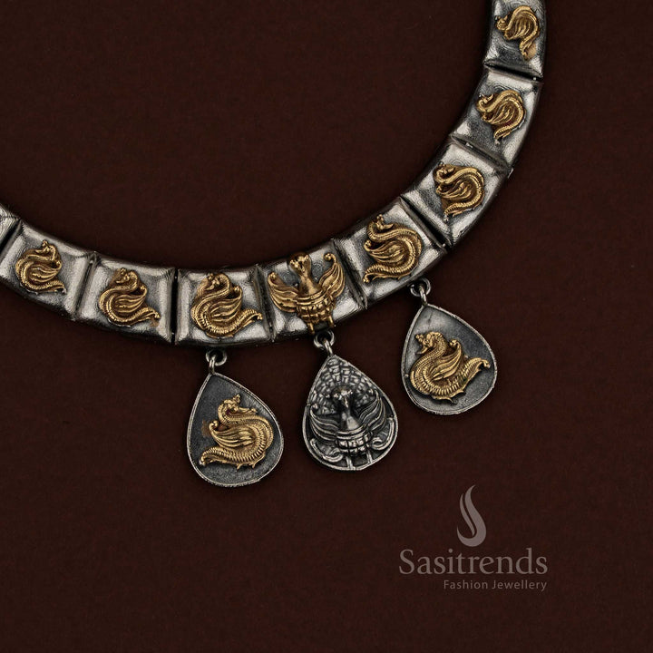 Sasitrends oxidised silver husli jewellery set designed with individual curved panels arranged in a crescent structure, raised peacock motif embossing highlighted in dual tone finish, sculpted teardrop drop elements adding movement, and matching earrings echoing the layered peacock-inspired design suitable for festive and cultural wear.