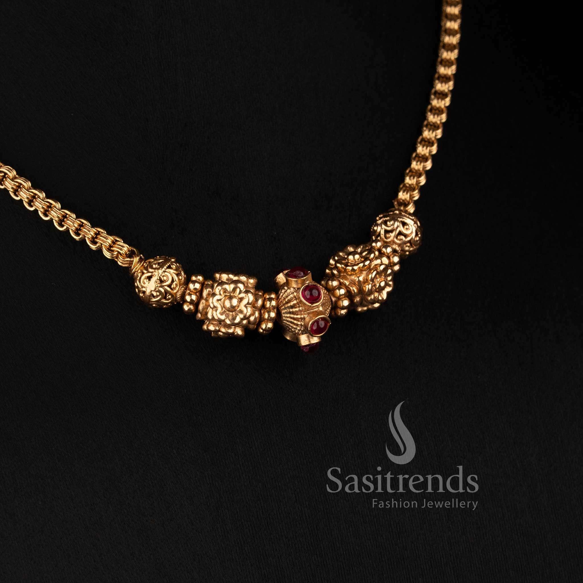 Sasitrends antique gold plated South Indian temple-inspired necklace set with floral carved beads, central ribbed barrel bead and round floral design
