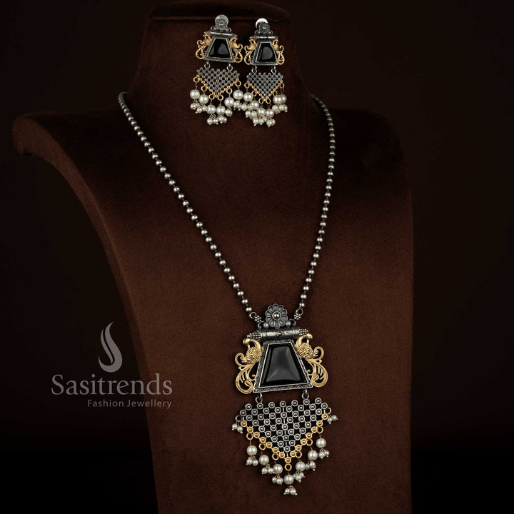 Antique oxidised silver plated floral peacock motif pendant chain necklace set from Sasitrends featuring a black Monalisa stone centerpiece, pearl detailing, rich antique finish, detailed peacock and floral carving, and matching earrings for temple and festive jewellery looks.
