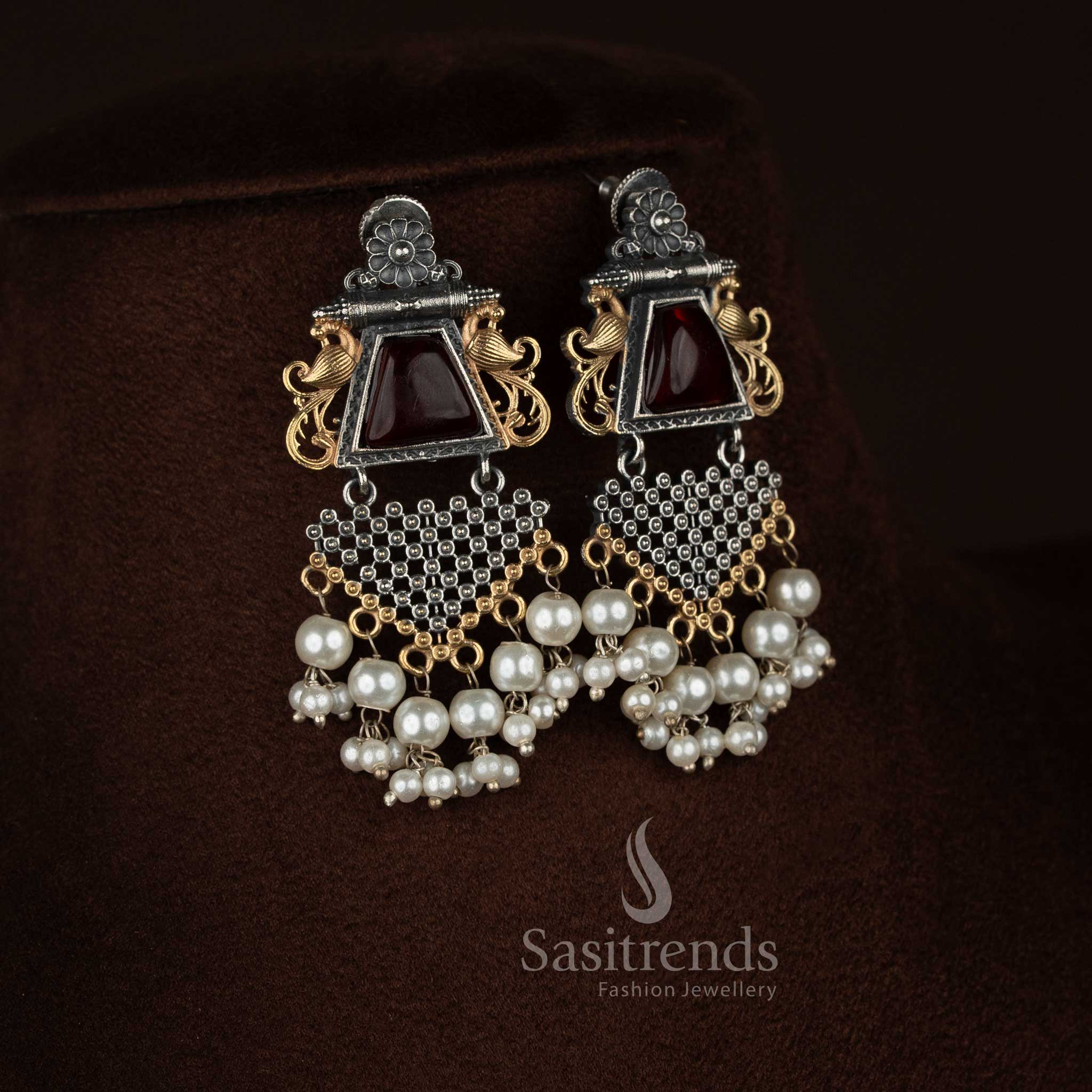 Sasitrends antique oxidised 92.5 silver plated pendant chain necklace jewellery set featuring an intricately designed floral peacock motif pendant with a central red Monalisa stone, pearl embellishments, engraved antique surface detailing, matching earrings with coordinated floral peacock design, and traditional oxidised chain for ethnic and festive styling.