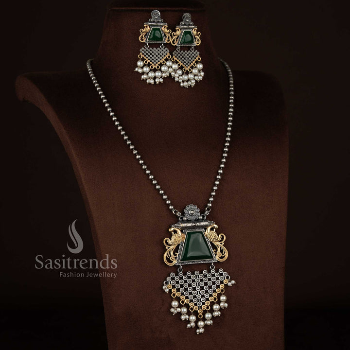 Sasitrends 92.5 silver plated antique oxidised necklace set designed with a green Monalisa stone floral peacock motif pendant, pearl highlights, intricate antique engraving, matching earrings with coordinated design elements, and traditional oxidised chain styling.
