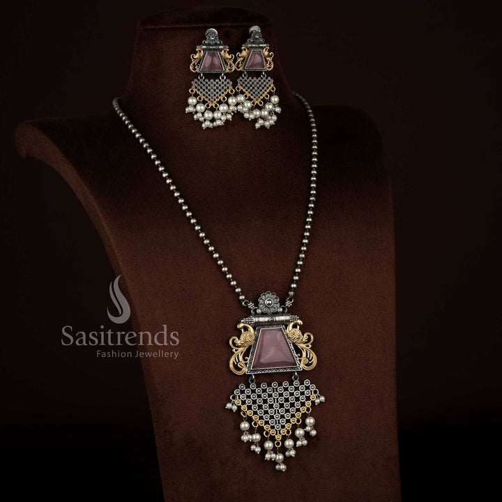 Antique oxidised 92.5 silver plated pendant chain necklace set by Sasitrends featuring a pink Monalisa stone floral peacock design, detailed floral framework, pearl detailing, antique oxidised surface texture, and matching earrings suitable for festive ethnic wear.
