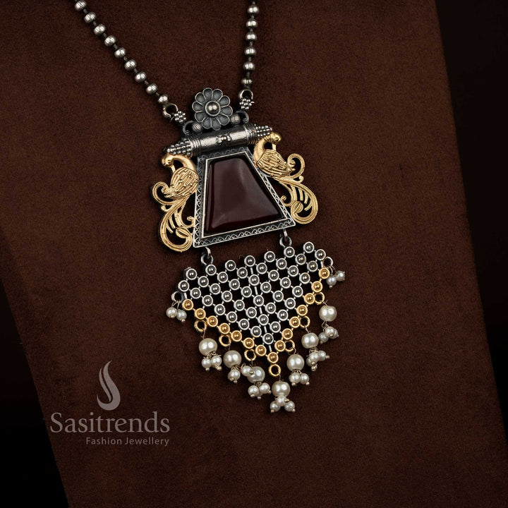 Sasitrends 92.5 silver plated antique oxidised necklace set designed with a red Monalisa stone floral peacock motif pendant, pearl highlights, intricate antique engraving, matching earrings with coordinated design elements, and traditional oxidised chain styling.
