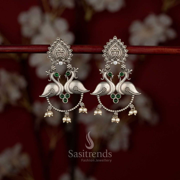 Sasitrends antique oxidised peacock motif earrings featuring temple inspired stud design and pearl hangings for traditional wear
