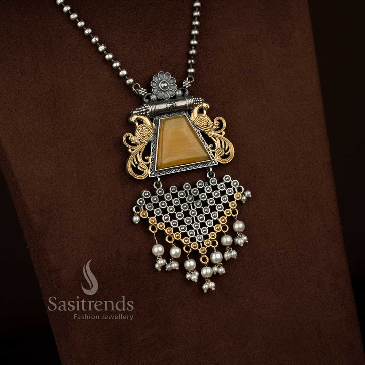 Antique oxidised silver plated floral peacock motif necklace set by Sasitrends showcasing a statement pendant with smooth Monalisa stone centerpiece, sculpted floral elements, pearl detailing, heritage oxidised finish, matching earrings reflecting the same design theme, and a complementary silver plated chain.