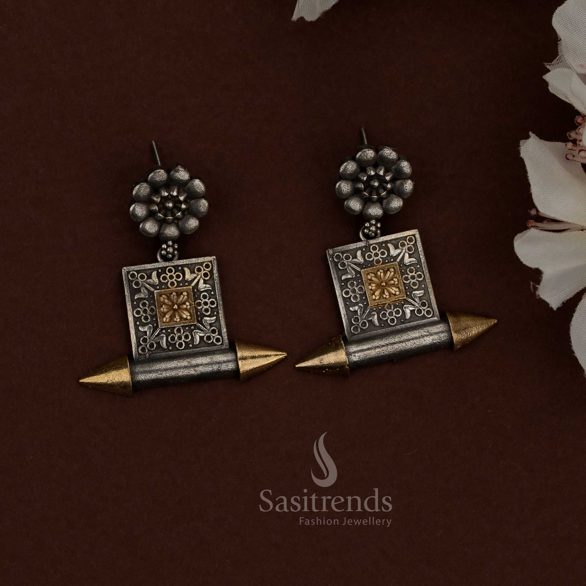 Sasitrends dual tone oxidised plated silver husli necklace set showcasing a thick curved tubular structure, polished and oxidised finish contrast, intricately engraved cylindrical center motif, architectural end detailing, traditional thread closure, and matching floral and geometric panel earrings reflecting bold ethnic heritage design.
