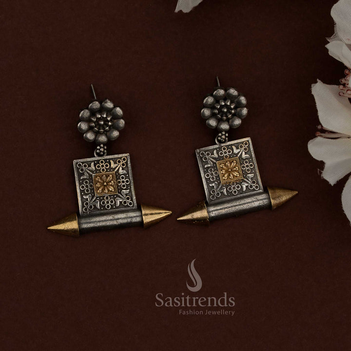 Sasitrends dual tone oxidised plated silver husli necklace set showcasing a thick curved tubular structure, polished and oxidised finish contrast, intricately engraved cylindrical center motif, architectural end detailing, traditional thread closure, and matching floral and geometric panel earrings reflecting bold ethnic heritage design.