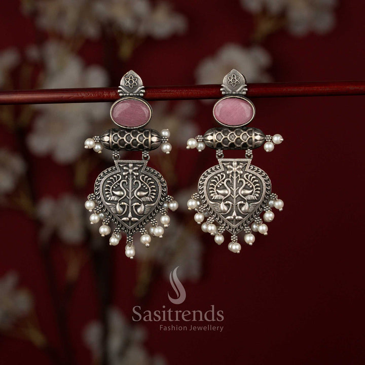 Charming pink Oxidised German Silver Temple-Inspired Layered Drop Earrings with Oval Stone Connector, Engraved Shield Motif and Pearl Cluster Detailing