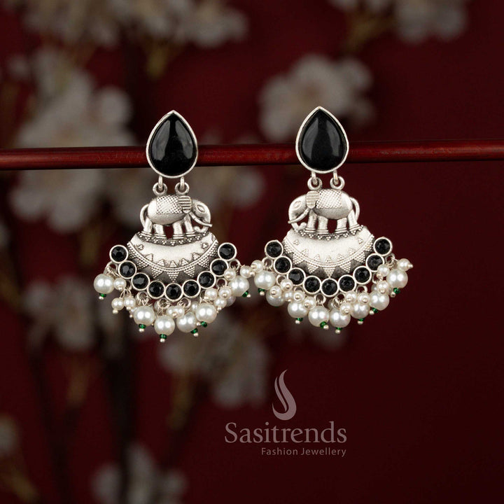 Sasitrends antique finish oxidised silver elephant earrings crafted in a curved crescent silhouette, adorned with radiant teardrop stones and layered pearl drops, perfect for ethnic celebrations and traditional occasions.