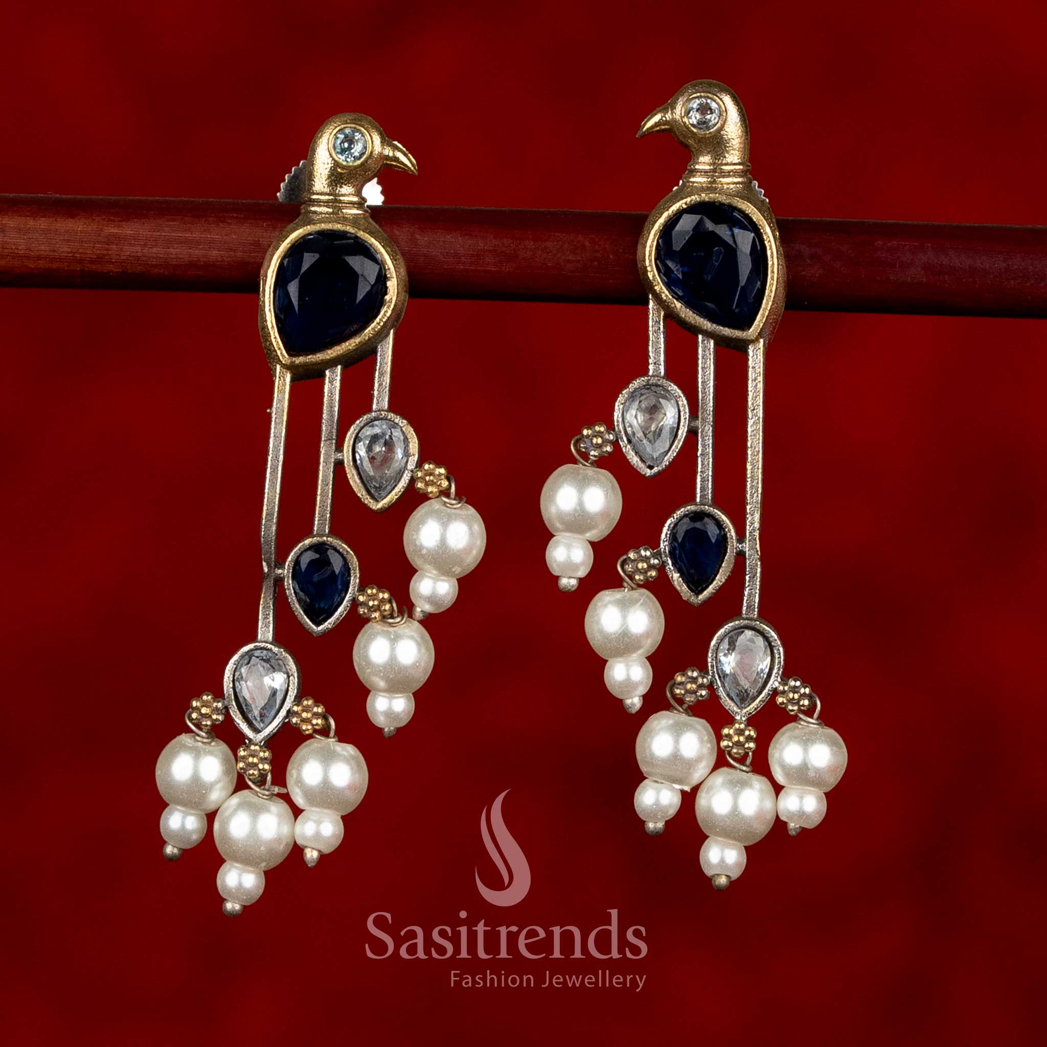 Sasitrends oxidised silver parrot motif earrings in blue and white colour combination featuring structured long silhouette and pearl embellishments
