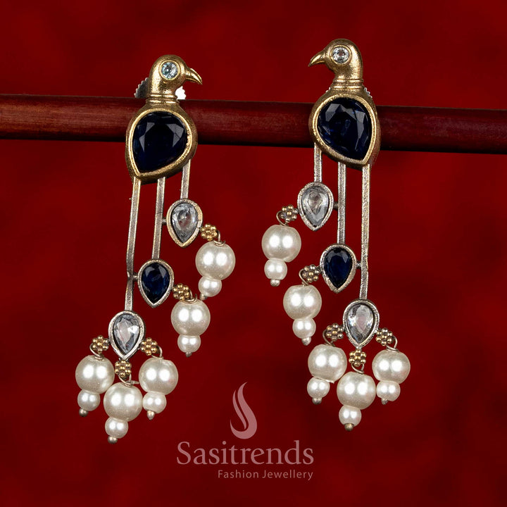 Sasitrends oxidised silver parrot motif earrings in blue and white colour combination featuring structured long silhouette and pearl embellishments
