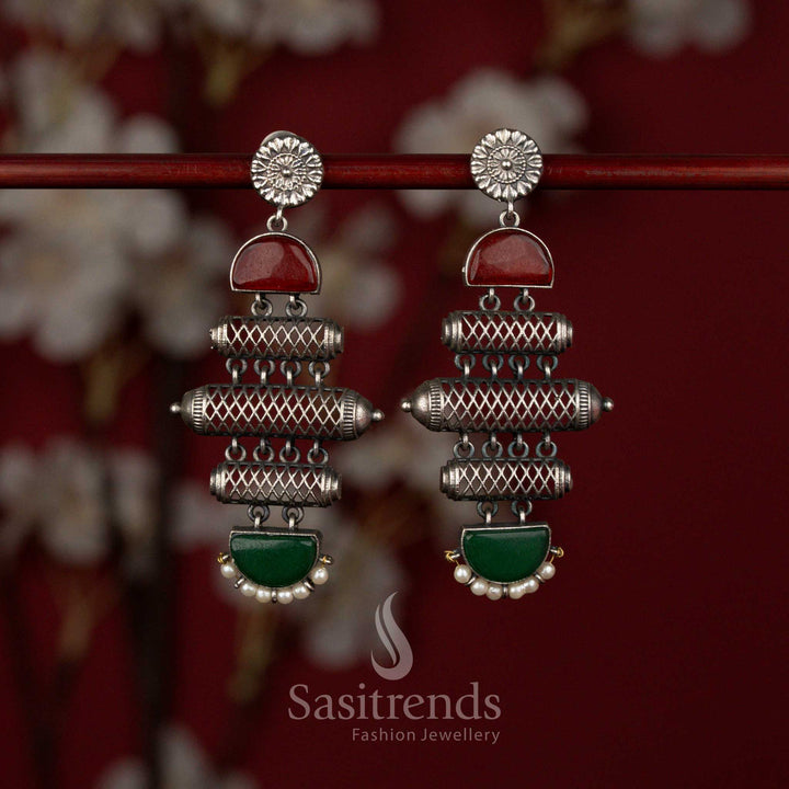 Bold oxidised silver plated earrings by Sasitrends showcasing a layered barrel silhouette, detailed cylindrical patterns, red green stone embellishments and pearl accents for statement traditional wear.