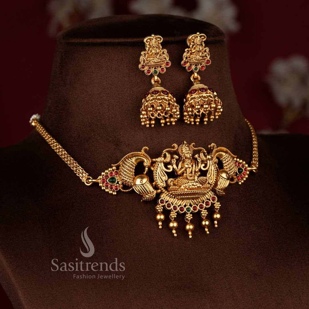 Sasitrends matte gold plated ruby green stone Lakshmi centrepiece choker with symmetrical peacock and drum motifs