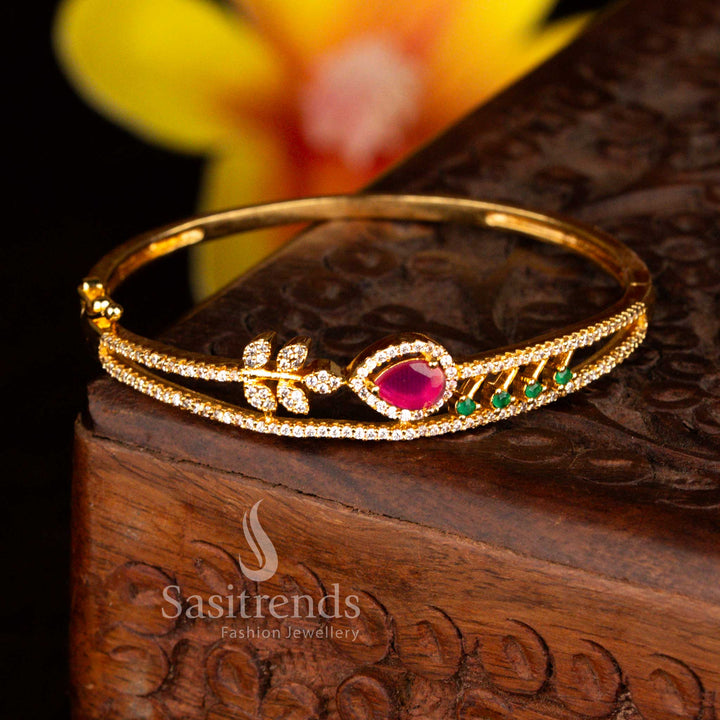 Sasitrends classic micro gold plated floral teardrop multi American diamond openable kada bracelet featuring a smooth locking mechanism and radiant gold tone polish.