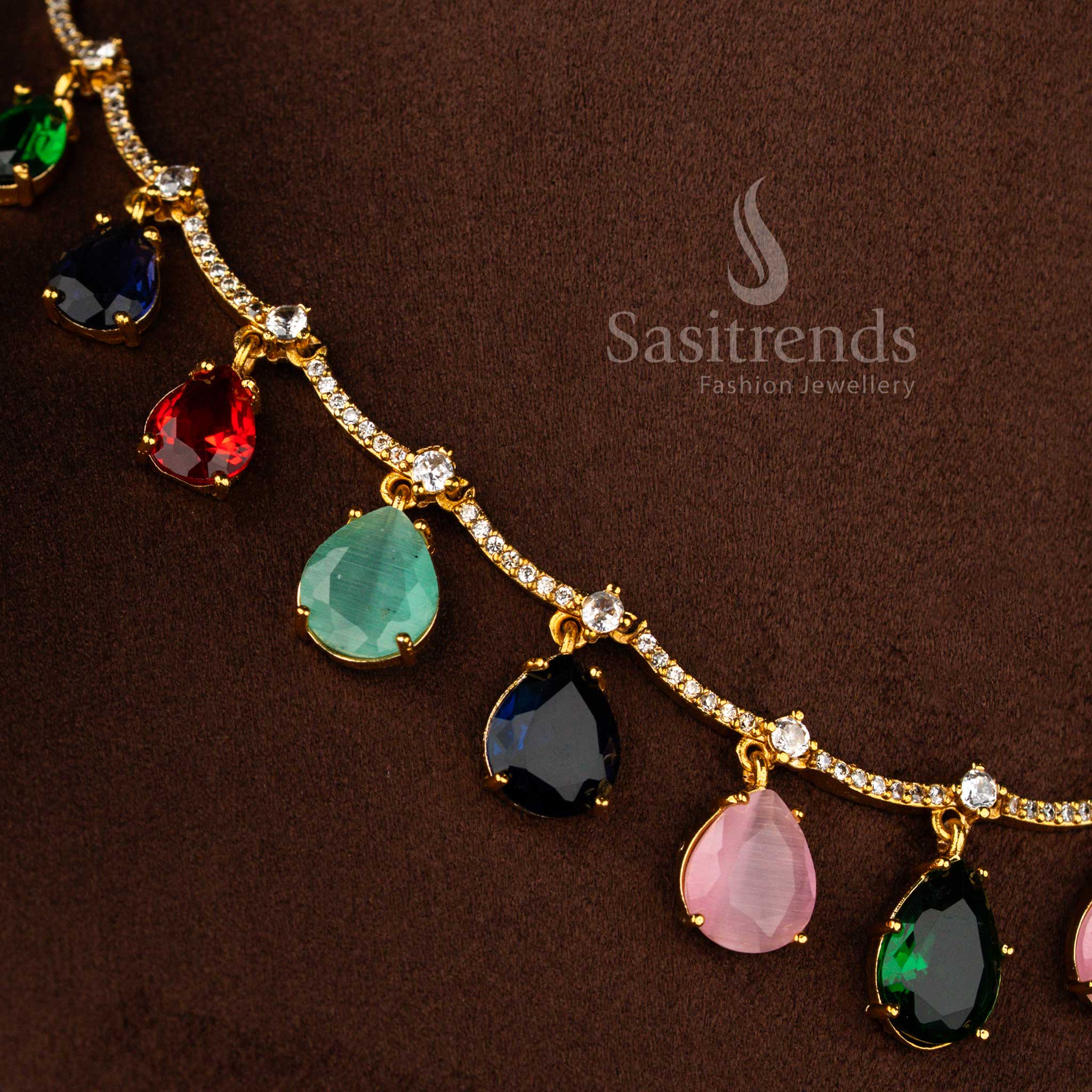 Sasitrends elegant matte gold plated Navarathna American Diamond necklace set with symmetrical drop elements and coordinated floral top earrings
