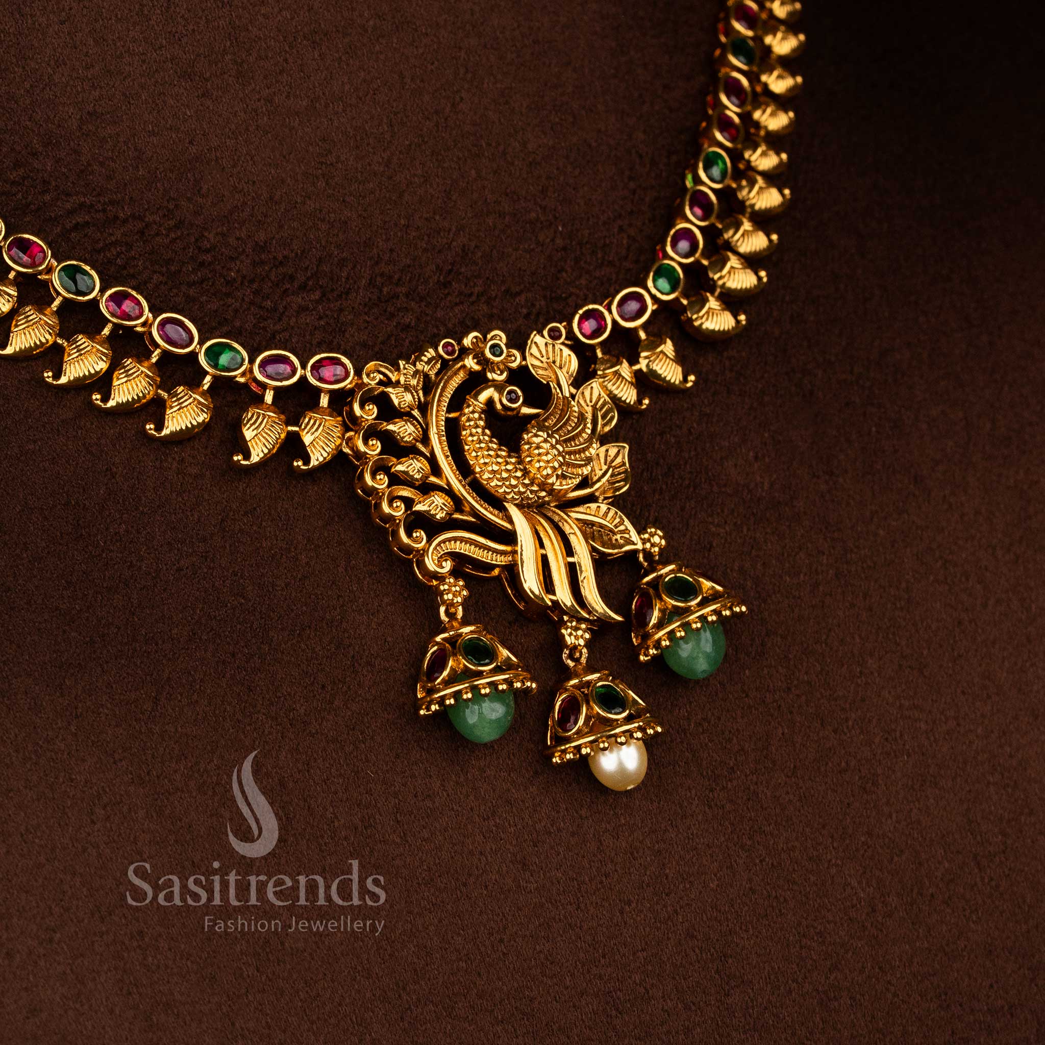 Sasitrends temple matte gold plated peacock pendant ruby green AD stone necklace set with leaf motifs and rich premium look