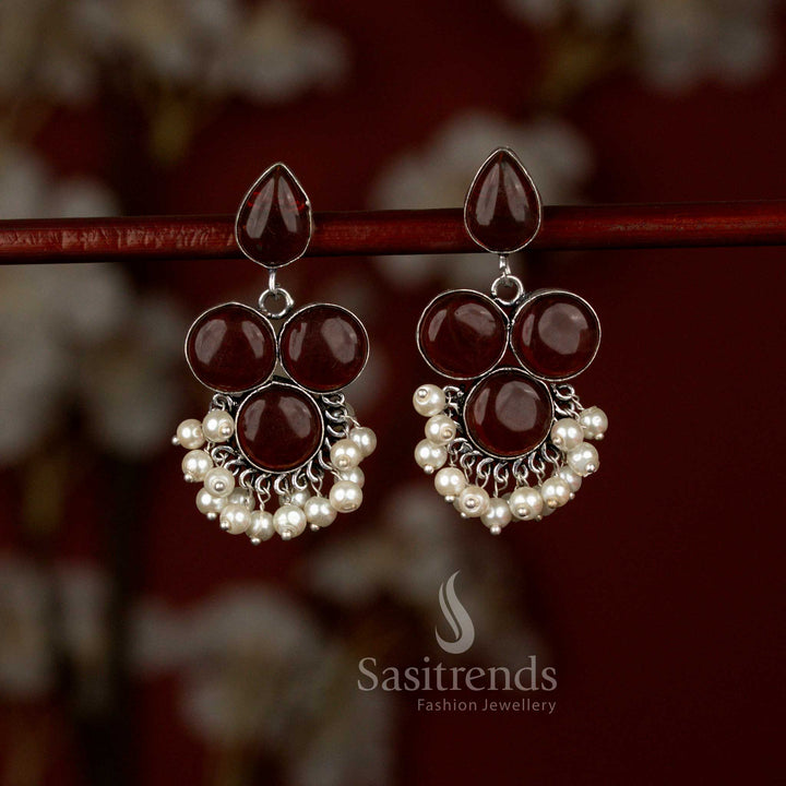 Elegant maroon oxidised silver Monalisa stone earrings from Sasitrends designed with a round stud top flowing into a teardrop frame, finished with subtle pearl drops perfect for workwear and casual gatherings.