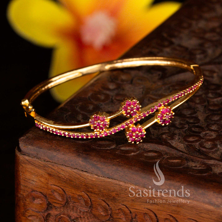Sasitrends elegant micro gold plated four floral-shaped crystal clusters ruby American diamond openable kada bracelet featuring refined craftsmanship, secure openable design and radiant gold lustre suitable for weddings and party styling.