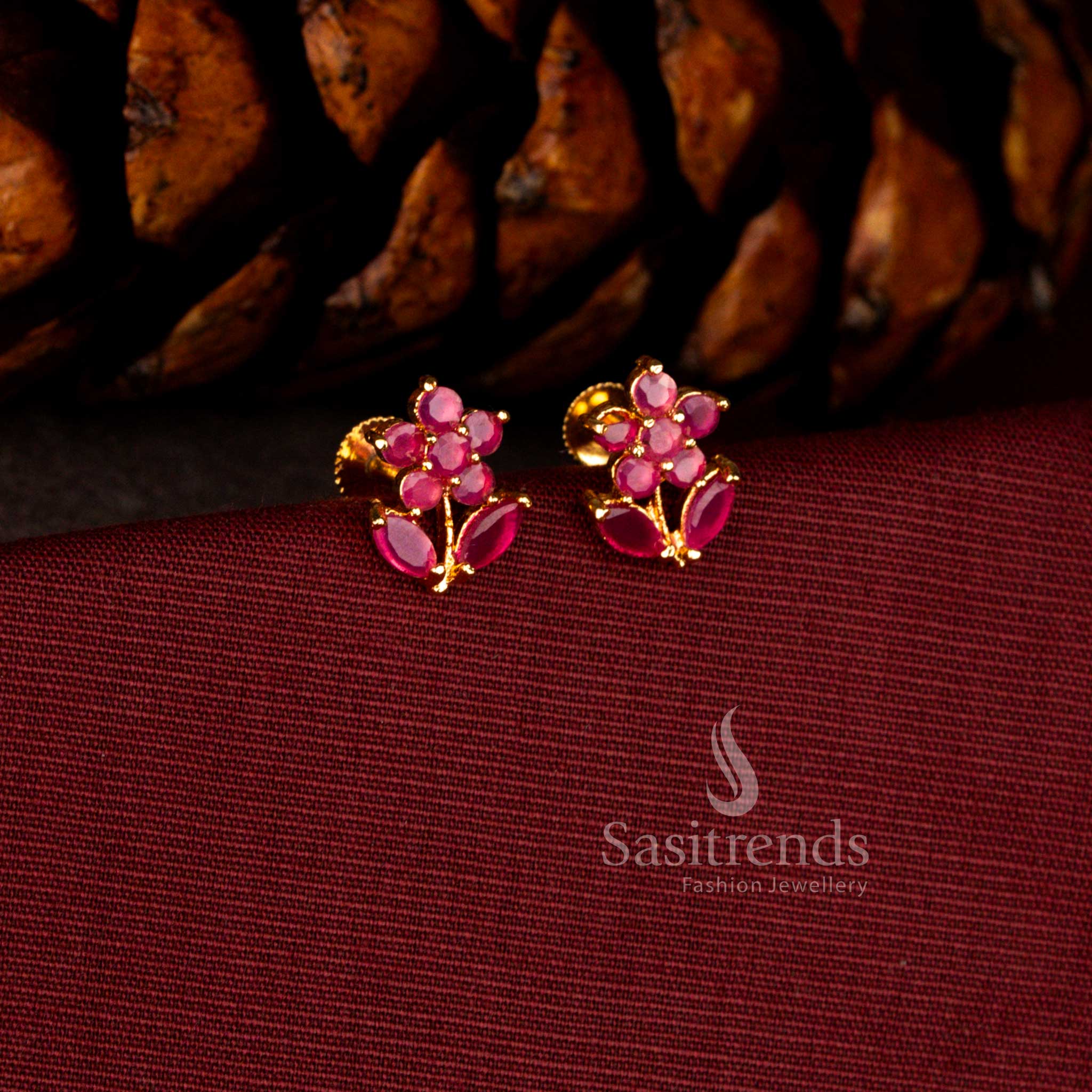 Sasitrends elegant one gram micro gold plated ruby AD stone earrings featuring a floral starburst design with marquise leaf craftsmanship and premium polish suitable for festive and party styling.