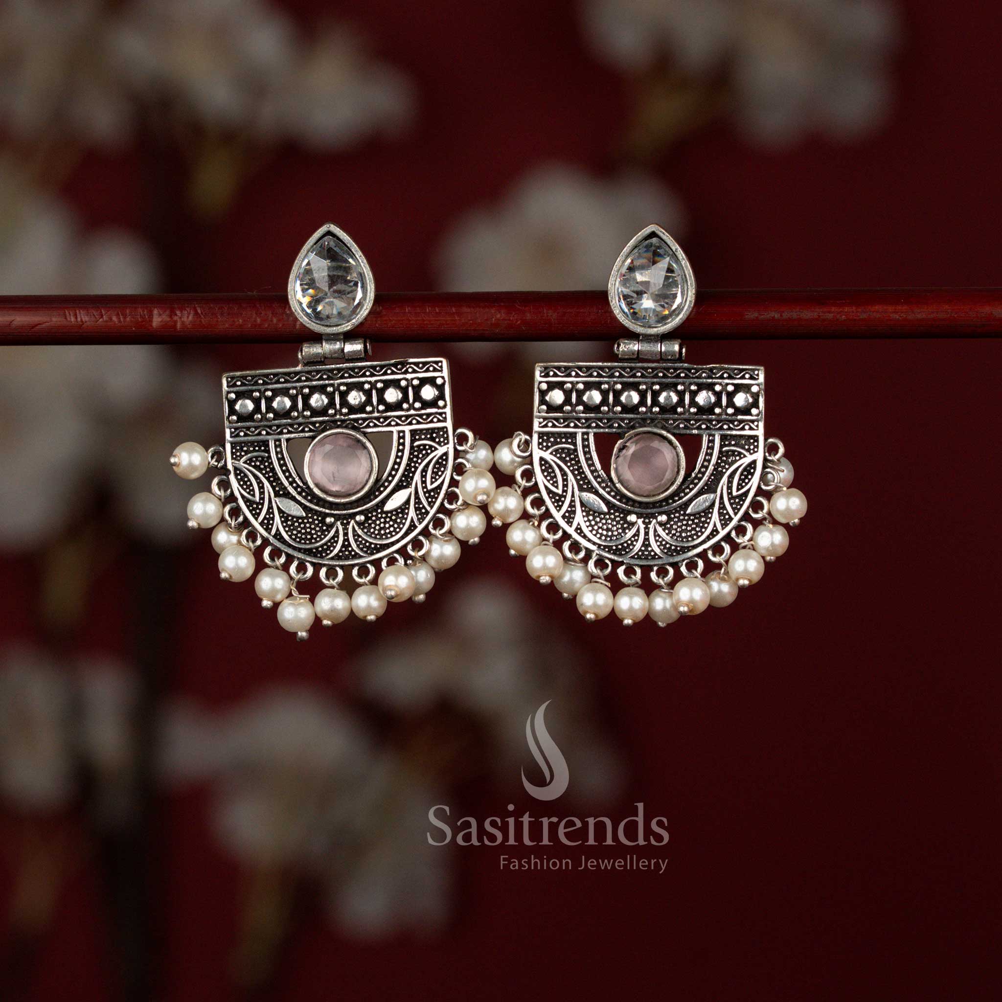 Elegant pink oxidised silver chandbali earrings from Sasitrends featuring a pear-shaped stone centerpiece framed in intricate detailing and finished with pearl drops, ideal for sarees, kurtis and special functions.