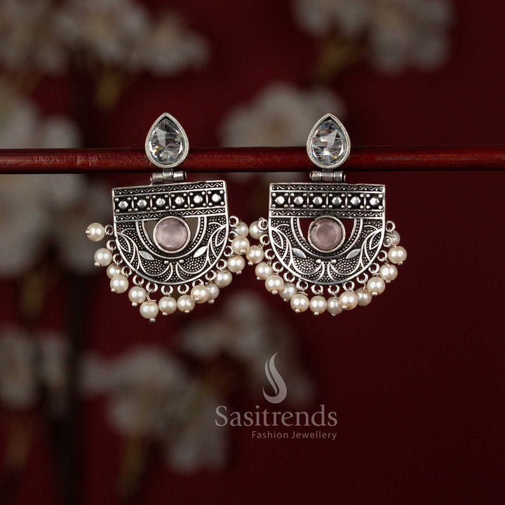 Elegant pink oxidised silver chandbali earrings from Sasitrends featuring a pear-shaped stone centerpiece framed in intricate detailing and finished with pearl drops, ideal for sarees, kurtis and special functions.