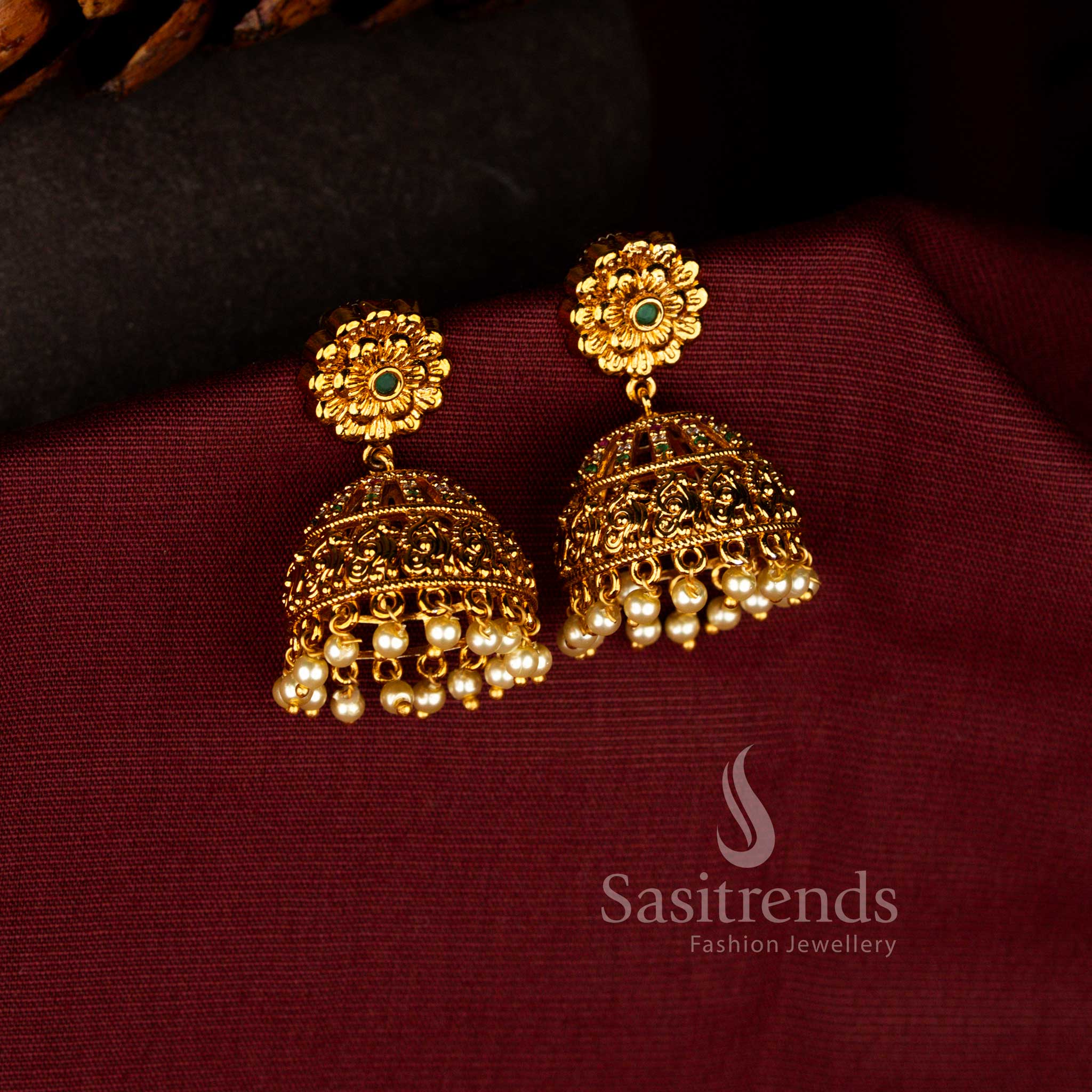 Sasitrends traditional matte gold plated floral motif temple jhumka earrings with ruby green AD stone stone and pearl drops