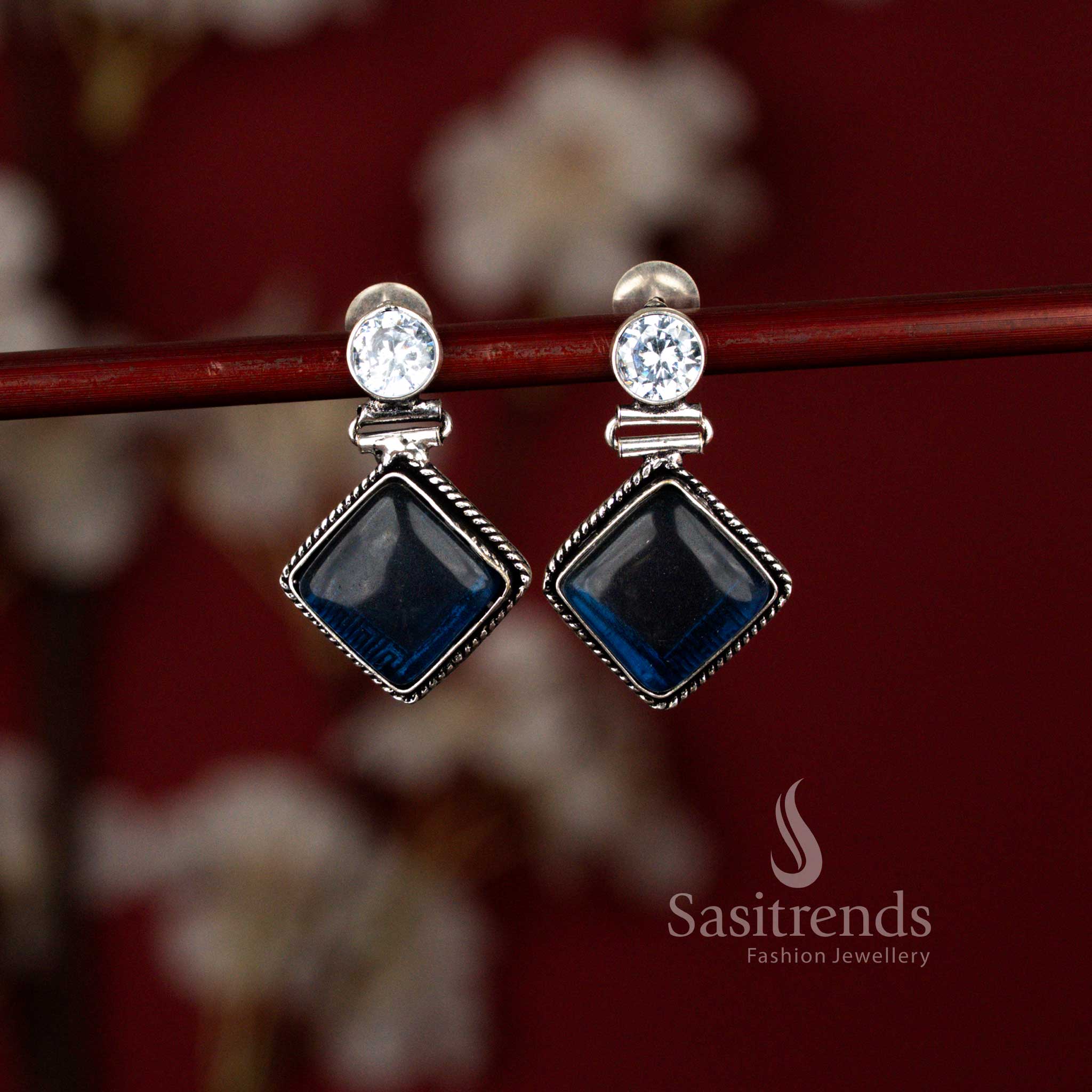 Geometric blue oxidised dangle earrings from Sasitrends featuring a polished Monalisa stone set within a rhombus frame, perfect for elevating semi-ethnic looks and everyday workwear styling.