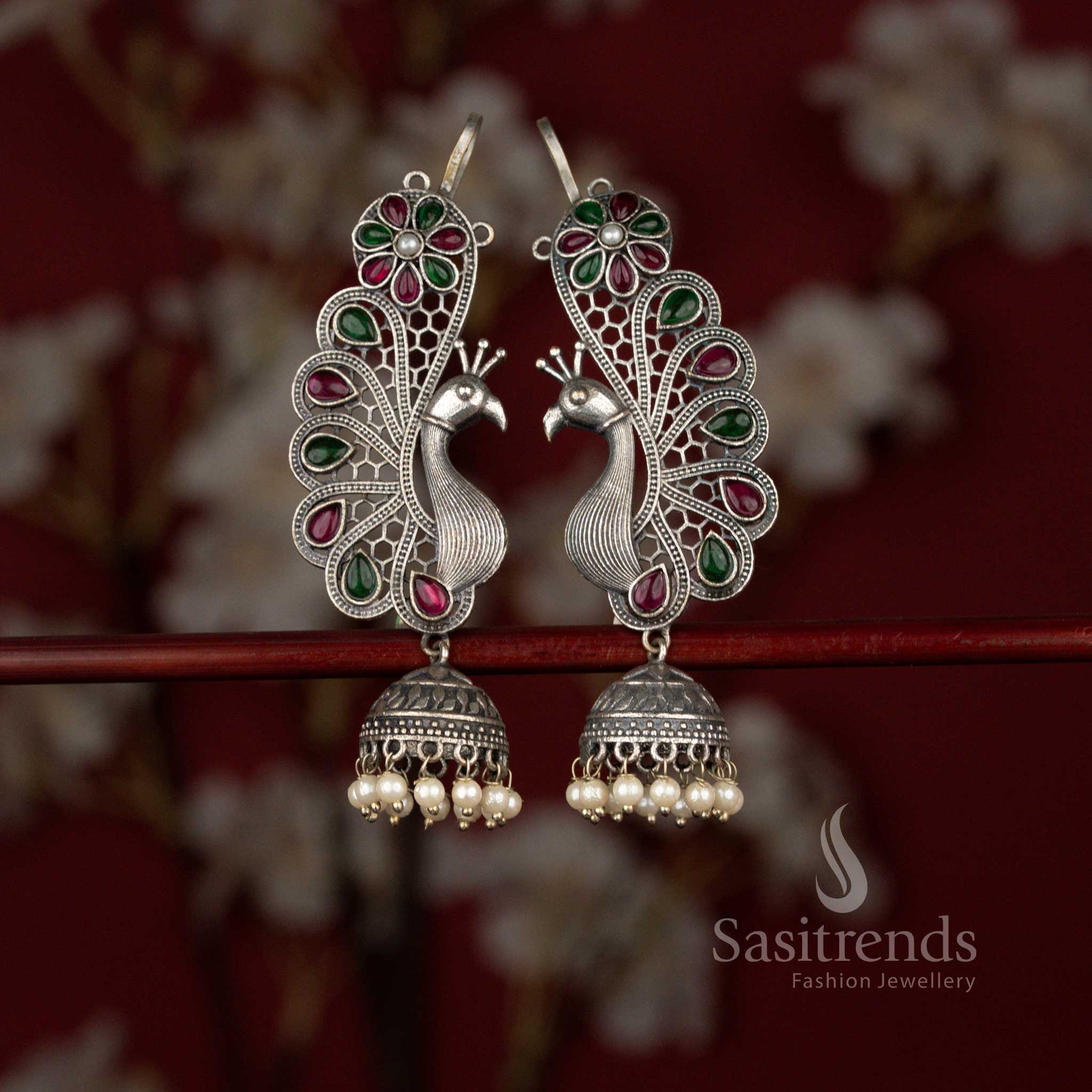 Grand 92.5 silver plated oxidised peacock floral earcuff jhumka earrings by Sasitrends featuring refined craftsmanship, teardrop ruby green stone embellishments and layered pearl hangings for festive and cultural celebrations.