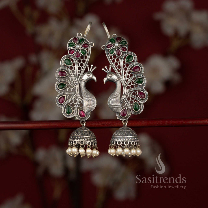 Grand 92.5 silver plated oxidised peacock floral earcuff jhumka earrings by Sasitrends featuring refined craftsmanship, teardrop ruby green stone embellishments and layered pearl hangings for festive and cultural celebrations.