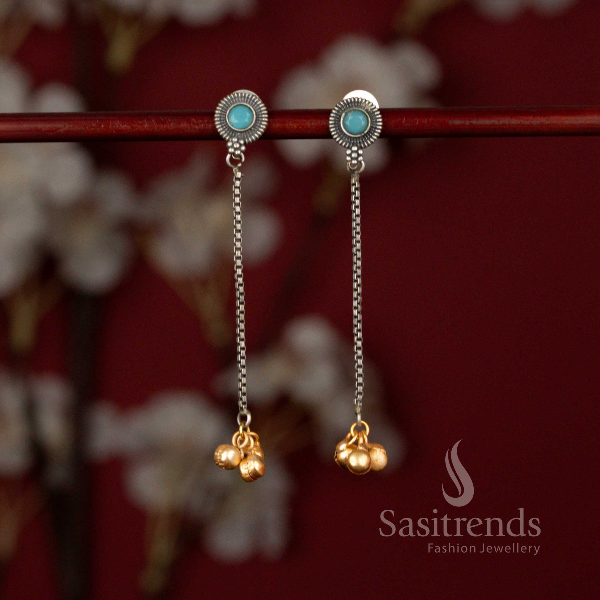 Sasitrends grand antique oxidised earrings featuring a radiant sunburst ocean blue stone design paired with a slender chain dangler and highlighted golden beads, offering a statement look for festive and traditional wear.