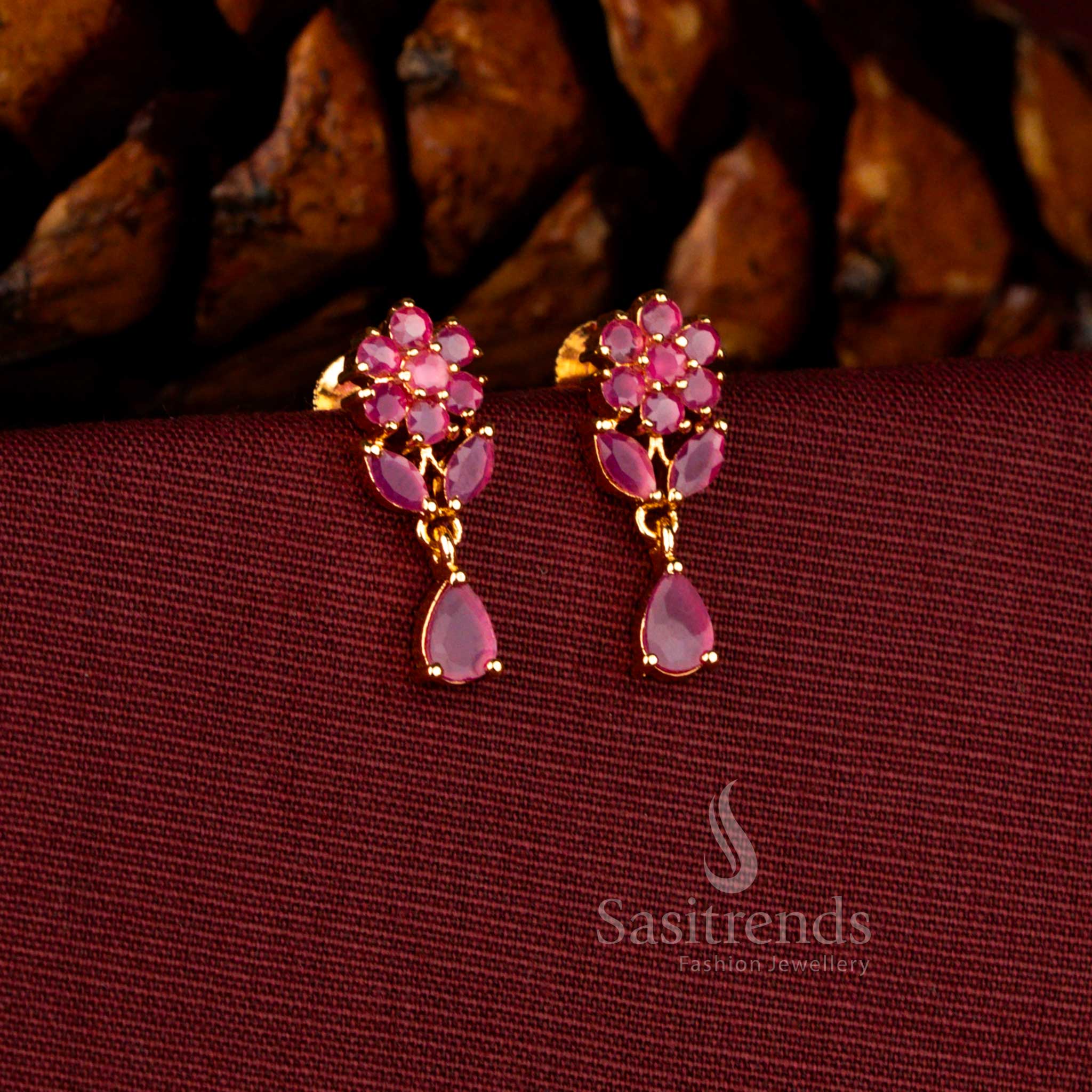Sasitrends grand micro gold plated drop earrings crafted with clustered pearls and a radiant teardrop ruby AD stone stud, offering a rich 1 gram jewellery polish that resembles real gold jewellery.