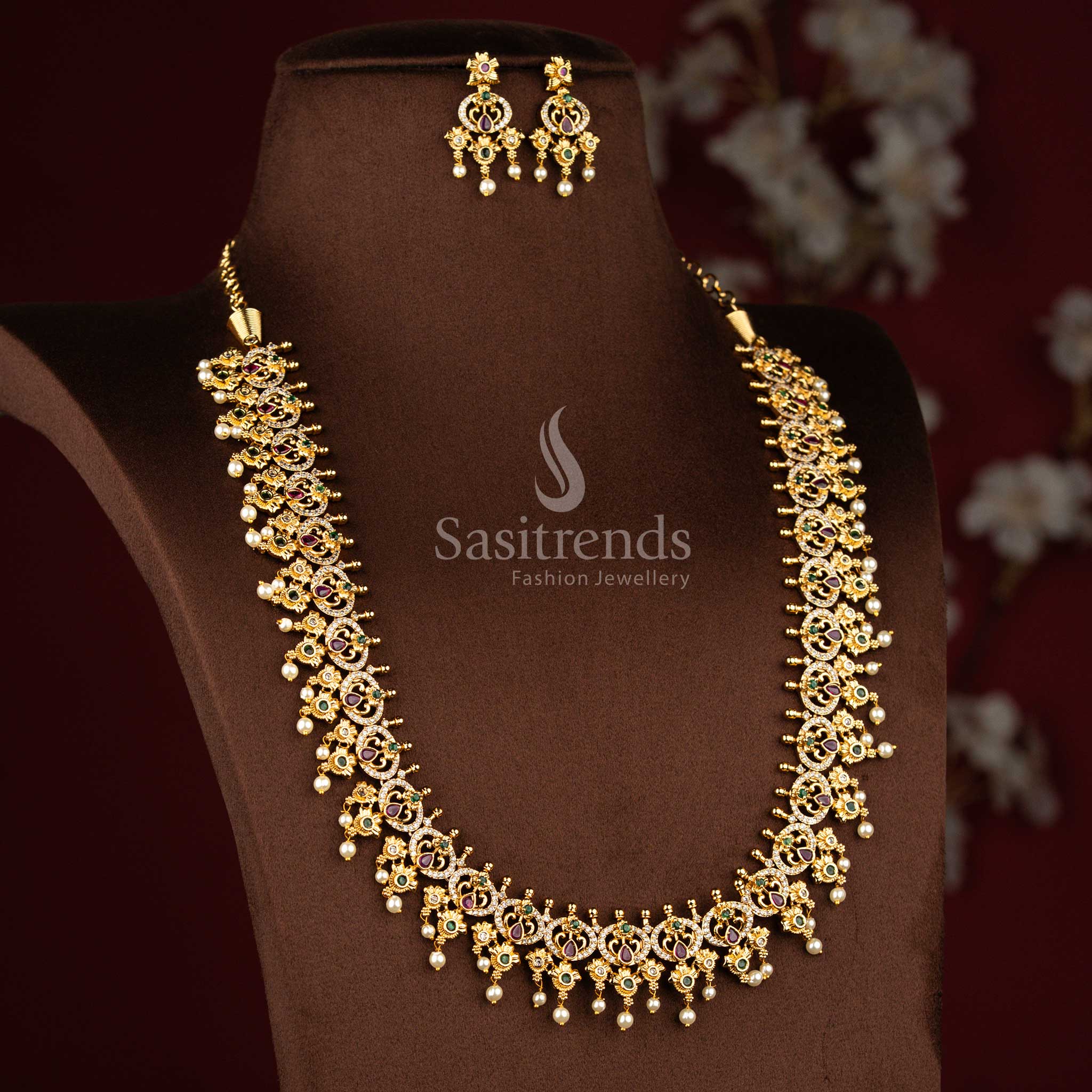 Sasitrends grand temple matte gold plated peacock teardrop floral motif pearl drop multi AD stone long necklace jewellery set featuring elegant temple craftsmanship for engagement rituals, poojas and cultural occasions