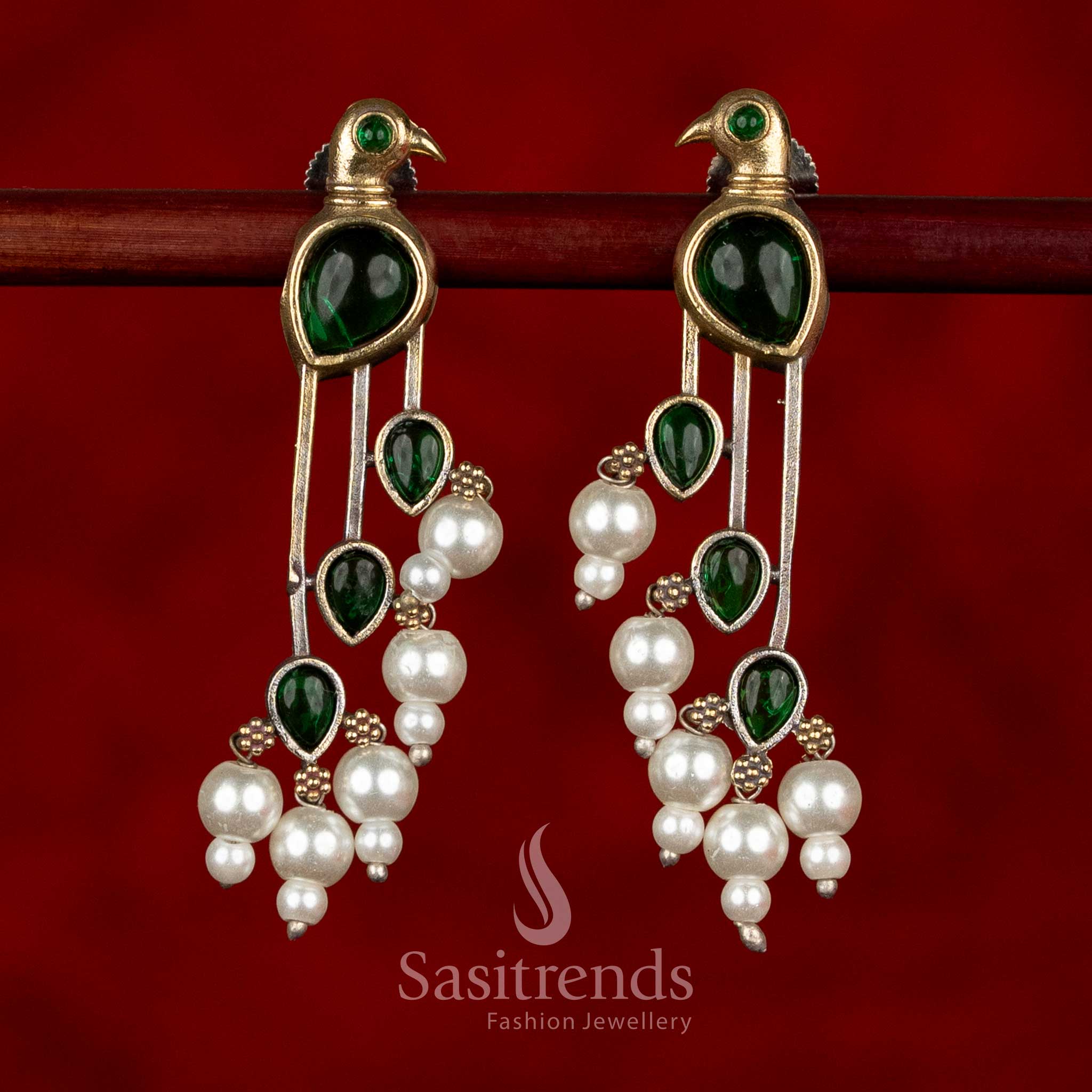 Sasitrends oxidised silver parrot motif earrings in rich green colour showcasing detailed stone arrangement and pearl drops for ethnic styling
