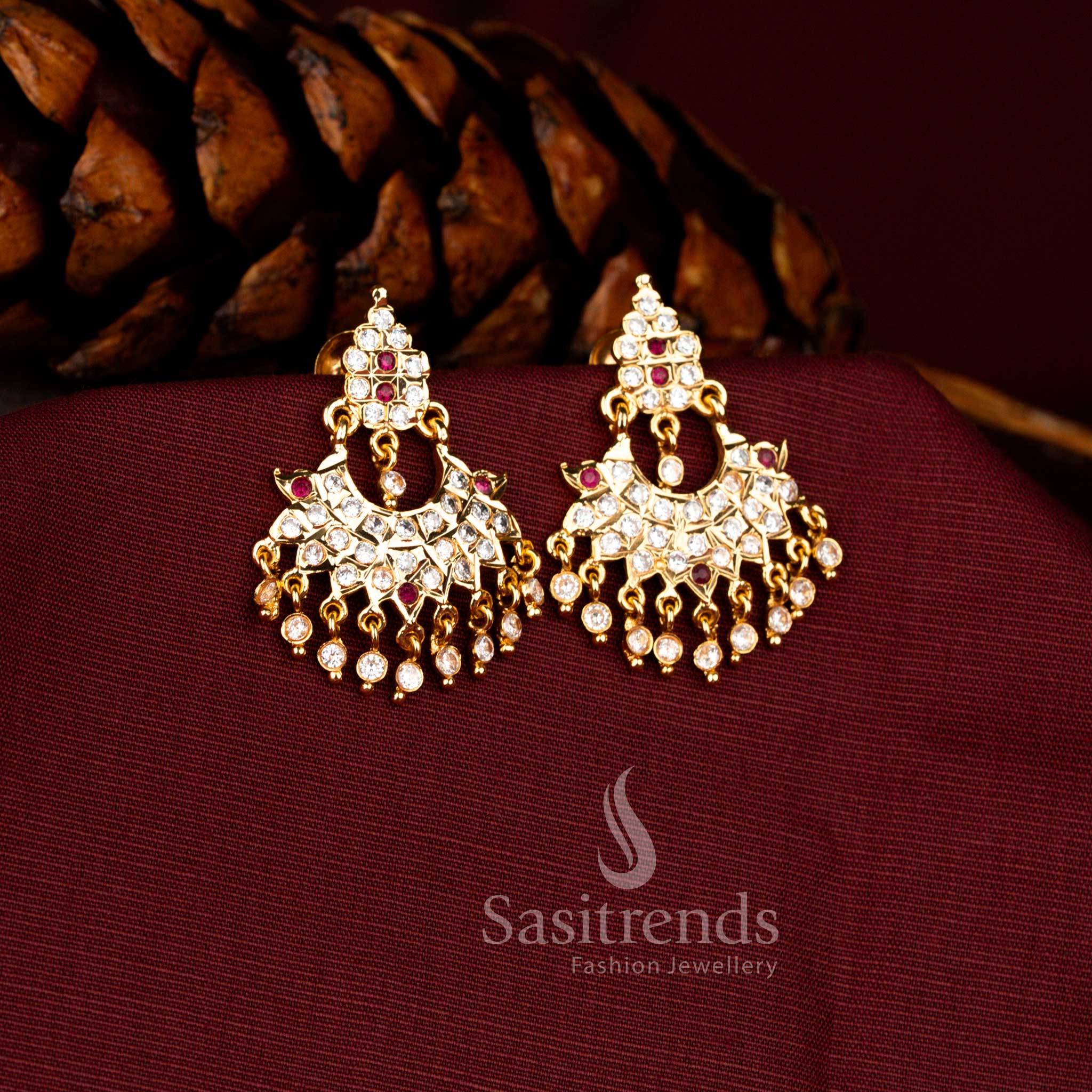 Sasitrends Impon micro gold plated white ruby AD stone motif inspired floral drop traditional temple earrings with detailed carving pattern and hanging stone beads, premium bridal jewellery that looks like real gold finish.
