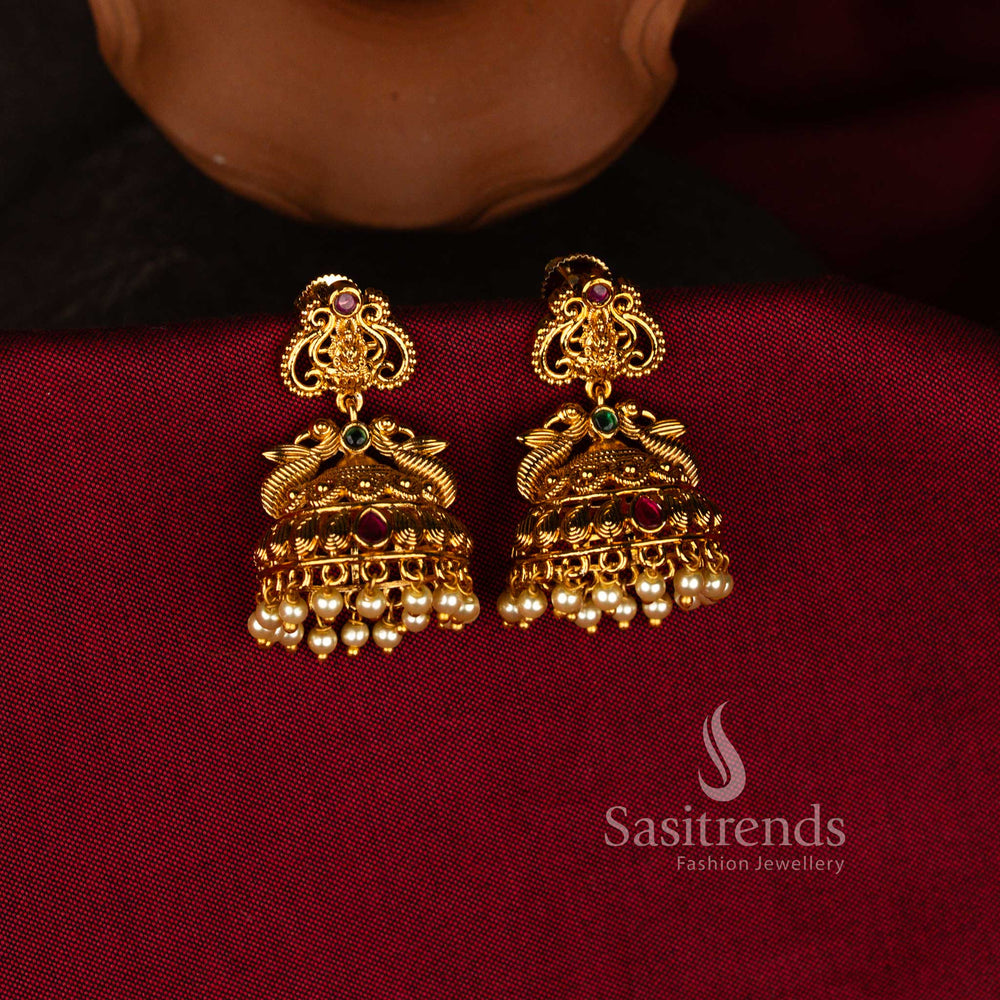 Sasitrends traditional matte gold plated Lakshmi peacock motif temple jhumka earrings with kemp stone and pearl drops