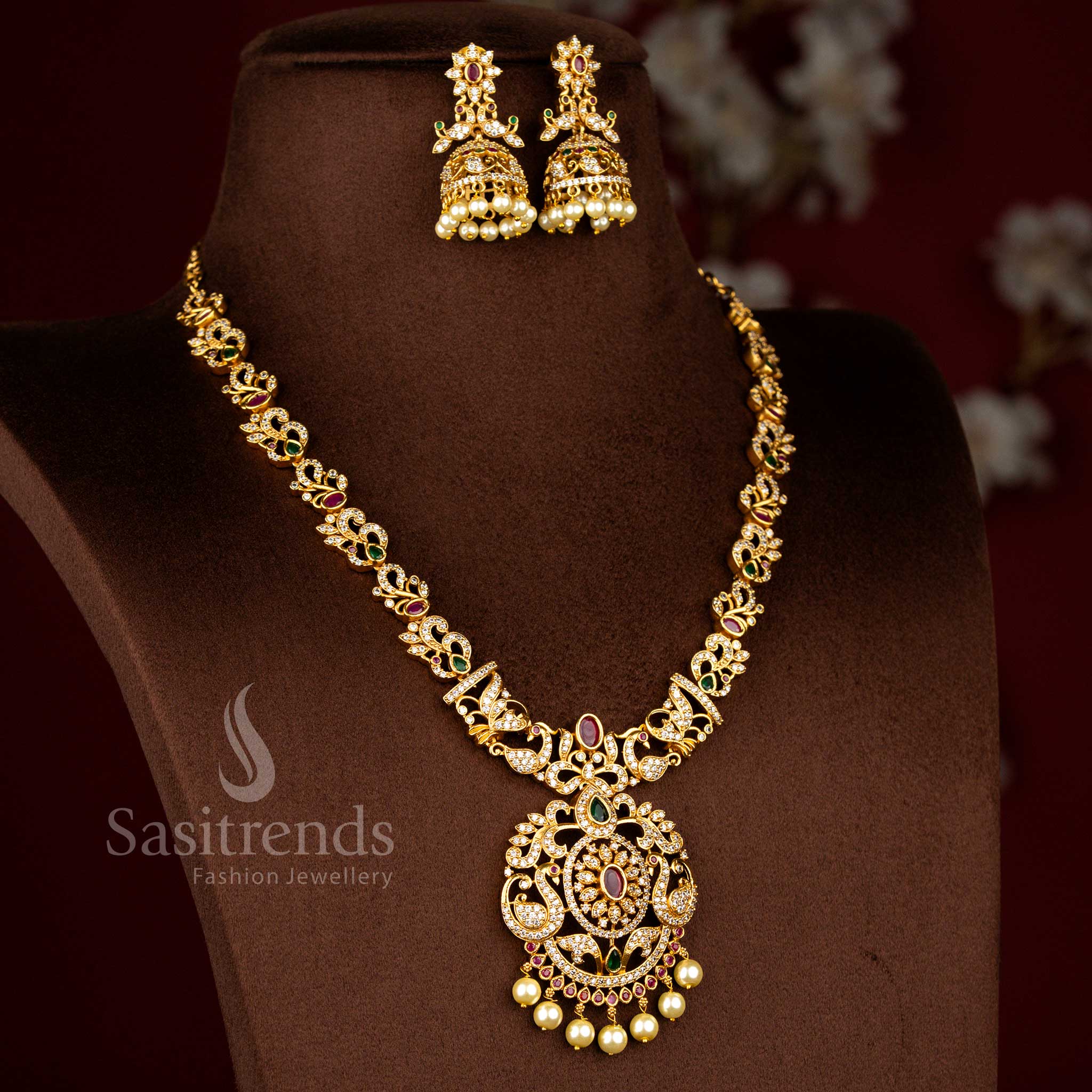 Sasitrends latest temple matte gold plated peacock and flower motifs bridal necklace jewellery set designed with rich traditional detailing for wedding and grand festive occasions