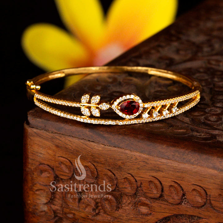 Sasitrends luxury micro gold plated floral teardrop white red American diamond openable kada bracelet designed with brilliant stones and polished gold tone offering a true real gold appearance.