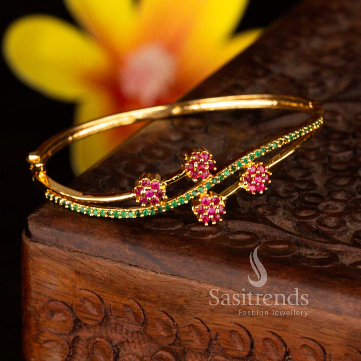 Sasitrends luxury micro gold plated four floral-shaped crystal clusters ruby green American diamond openable kada bangle designed with intricate stone detailing and a smooth openable mechanism ideal for bridal and grand occasions.