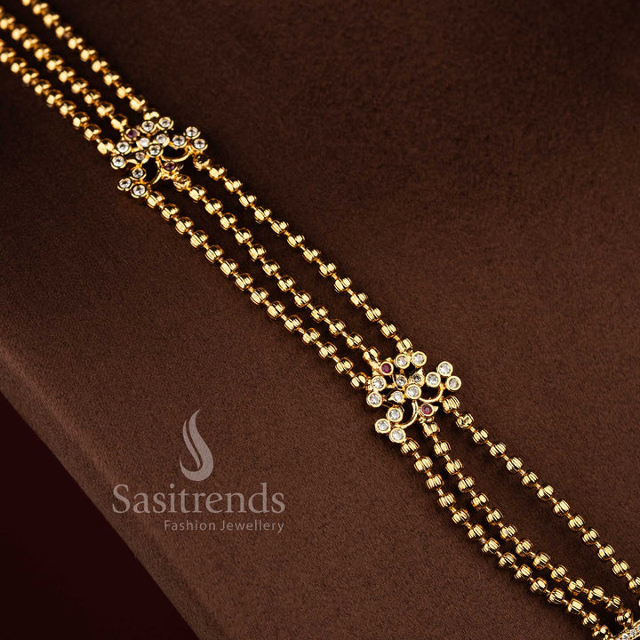 Sasitrends traditional matte gold plated multi AD stone long haram jewellery set with structured three strand chain and detailed temple motifs