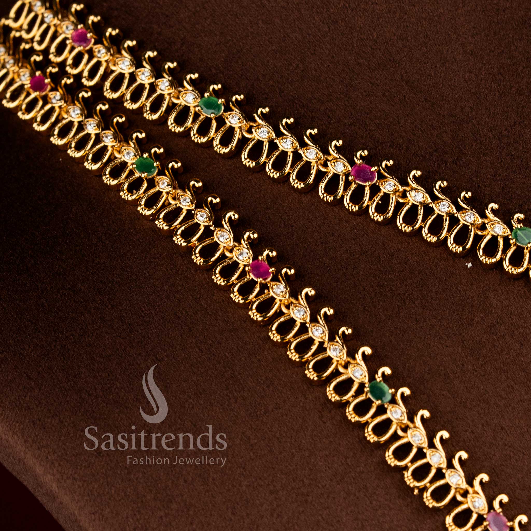 Sasitrends bridal temple matte gold plated multi AD stone necklace set with structured loop chain design and ornate floral peacock centerpieces 