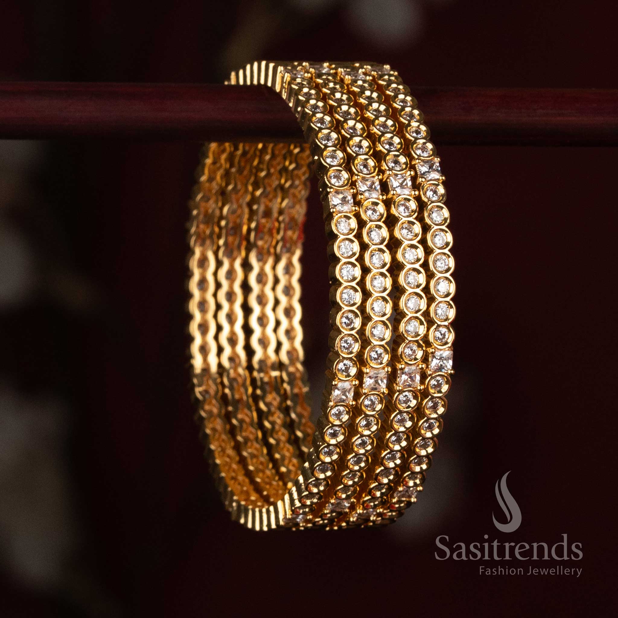 
Sasitrends Micro Gold Plated American Diamond stone studded designer bangle with multiple rows of round stone detailing and structured accents
