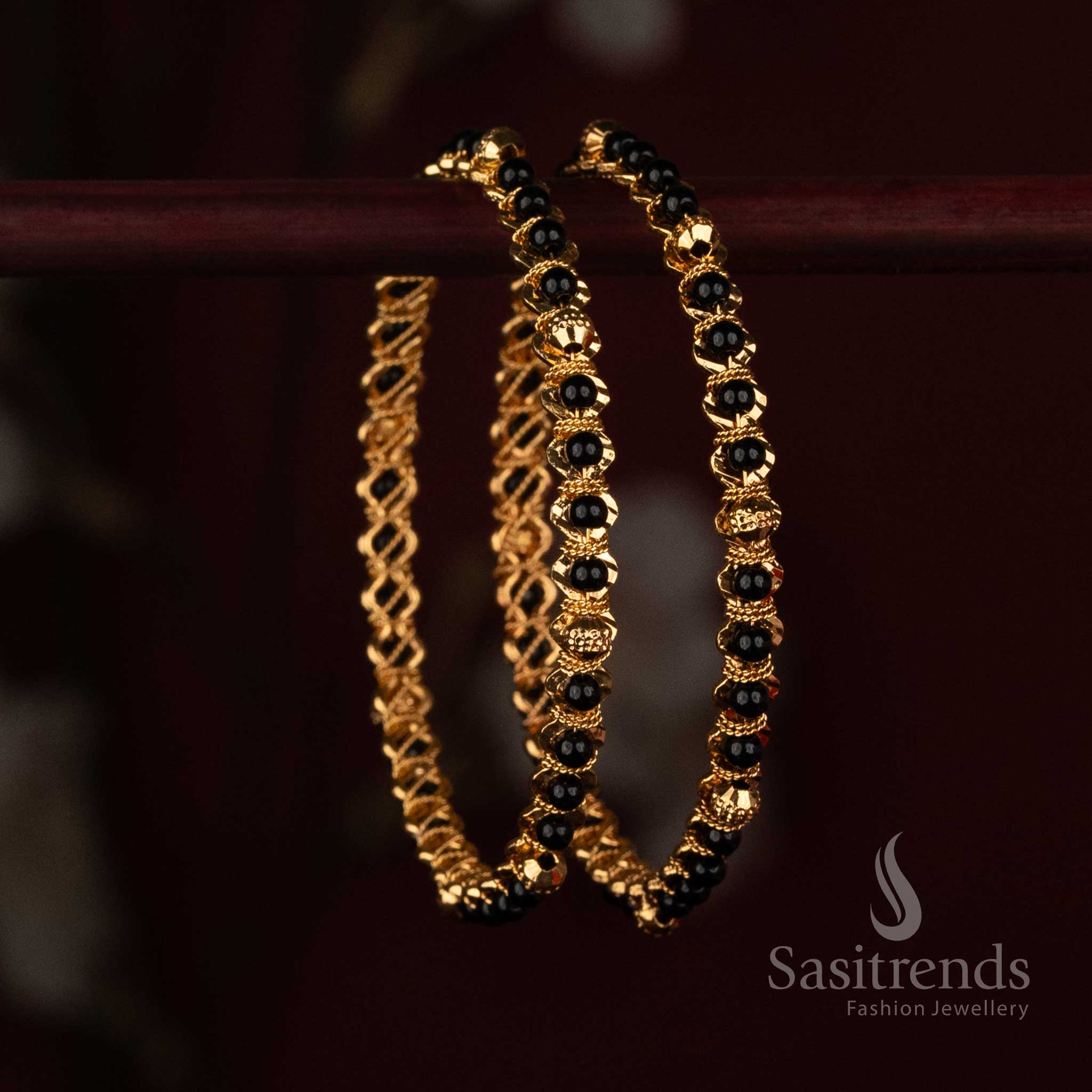
Sasitrends Micro Gold Plated black bead designer bangle with ornamental gold spacer detailing arranged throughout the wrist design
