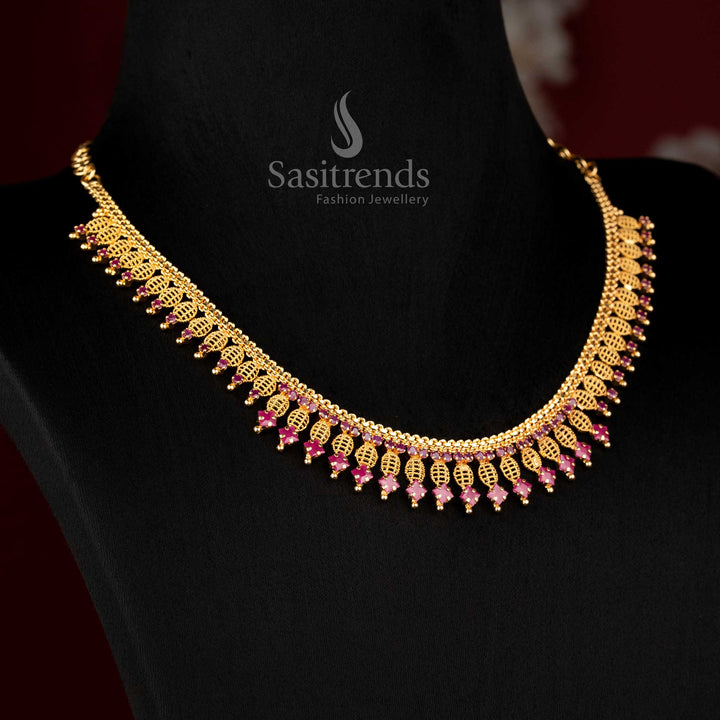 Micro gold plated ruby AD stone traditional necklace featuring intricate leaf lattice craftsmanship with detailed hanging drop elements and rich structured design by Sasitrends 