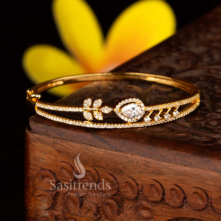 Sasitrends modern micro gold plated floral teardrop white American diamond openable kada bracelet featuring sleek styling and brilliant stones perfect for party wear.