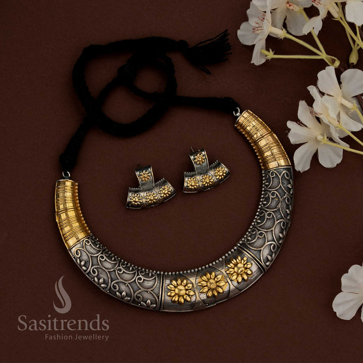 Sasitrends 92.5 dual tone silver oxidised plated husli jewellery set featuring a bold crescent necklace design with continuous engraved scrollwork patterns, raised floral embossed panels, structured surface detailing, traditional thread fastening, and matching earrings designed for ethnic heritage styling and festive wear.