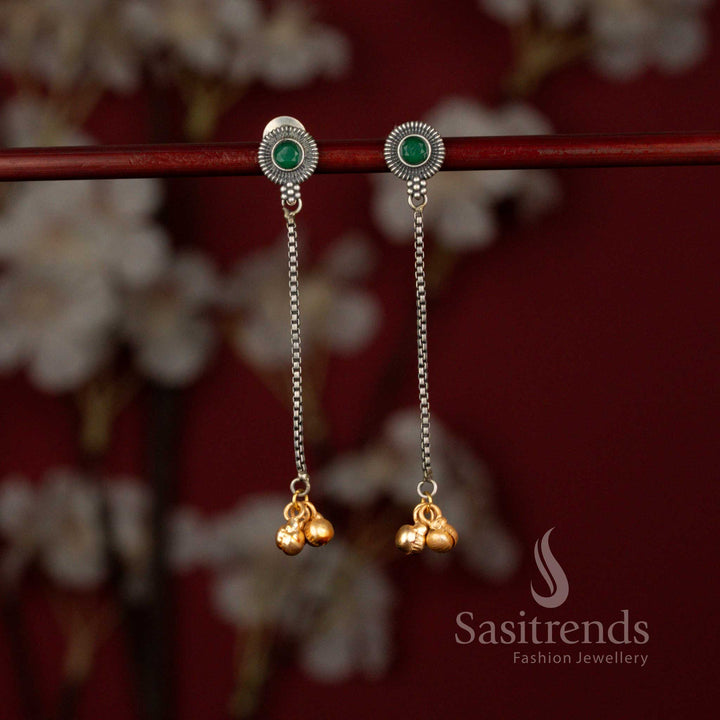 Elegant oxidised 92.5 silver plated earrings from Sasitrends designed with a detailed sunburst green stone top, flowing linear chain structure and subtle golden bead embellishments perfect for sarees and festive outfits.